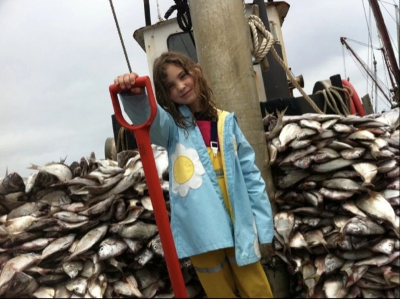 Olivia unloading a boatload of fish as a little girl.