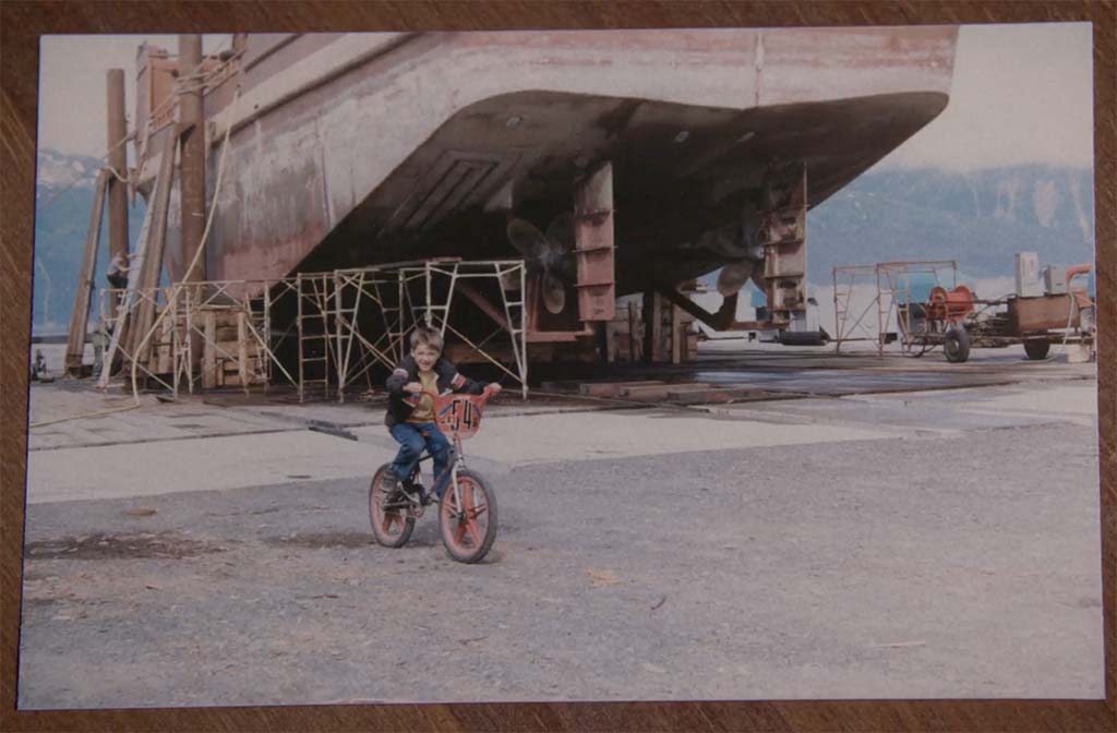 Kid riding a bike in front of the Arctic Lady before it was completed