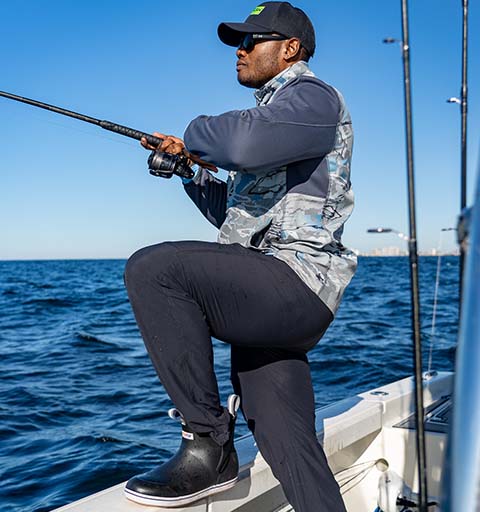 Lionel on his boat in the ocean, fishing.