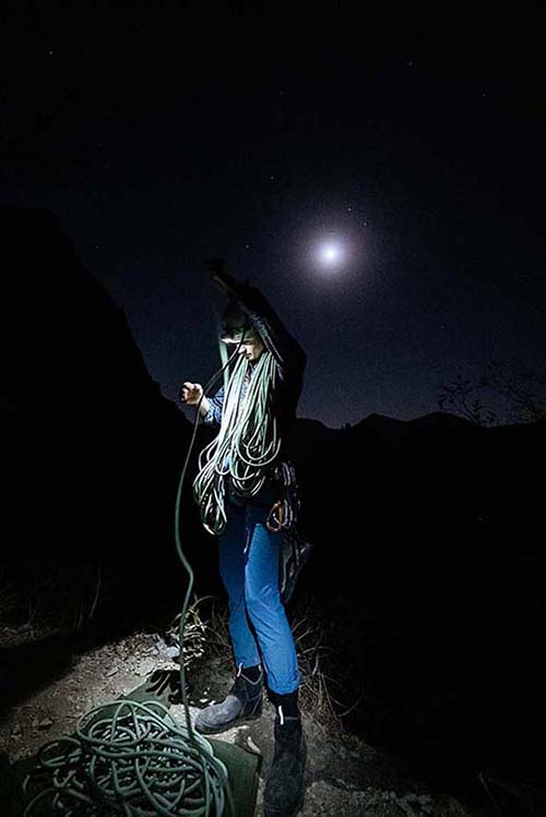 Organizing our gear under the moonlight at the base of Time Wave Zero