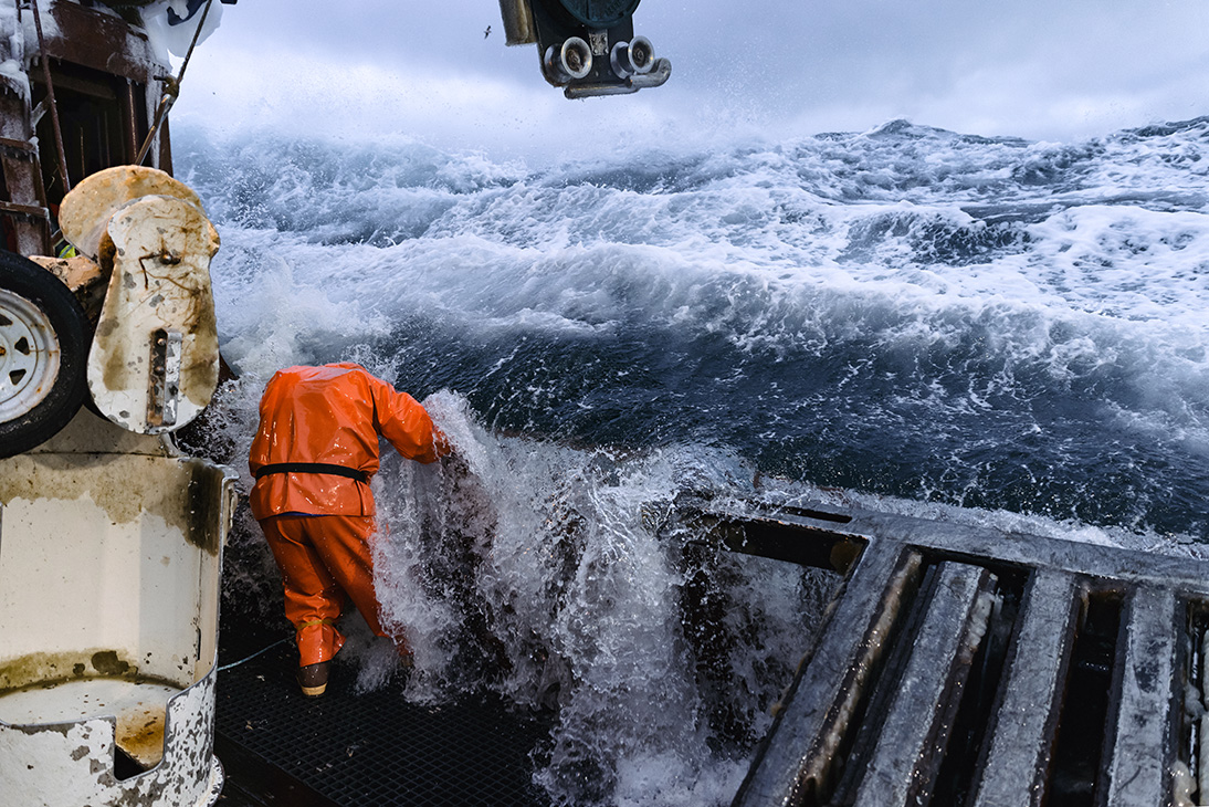 Arctic lady getting hit by a wave