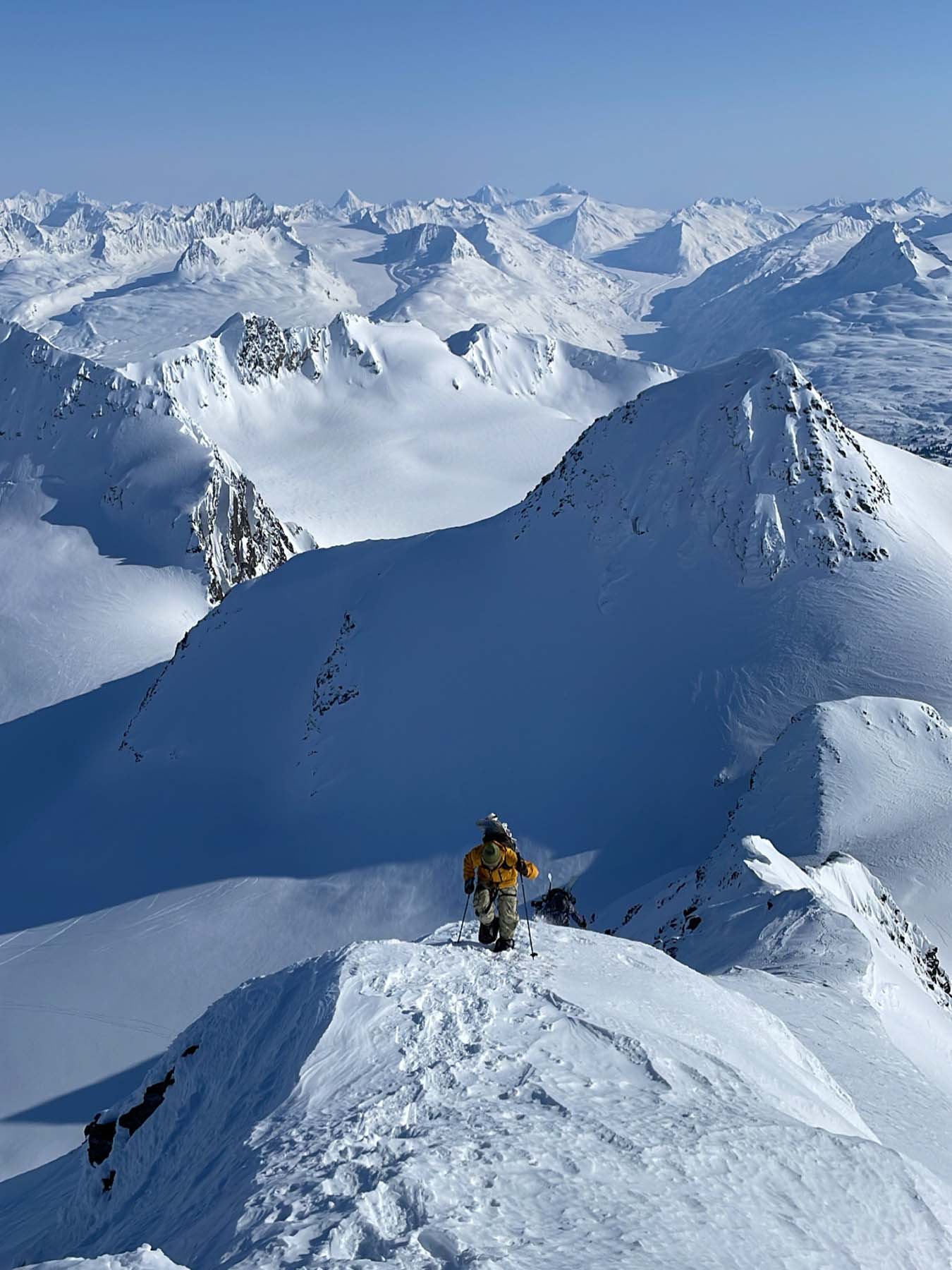 Standing on the peak looking towards the vast, snowy landscape