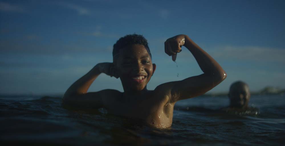 Lionel's student, flexing biceps in the water