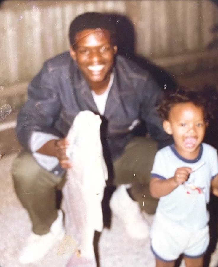Lionel as a young boy pictured with his father, who is holding up a large fish. 