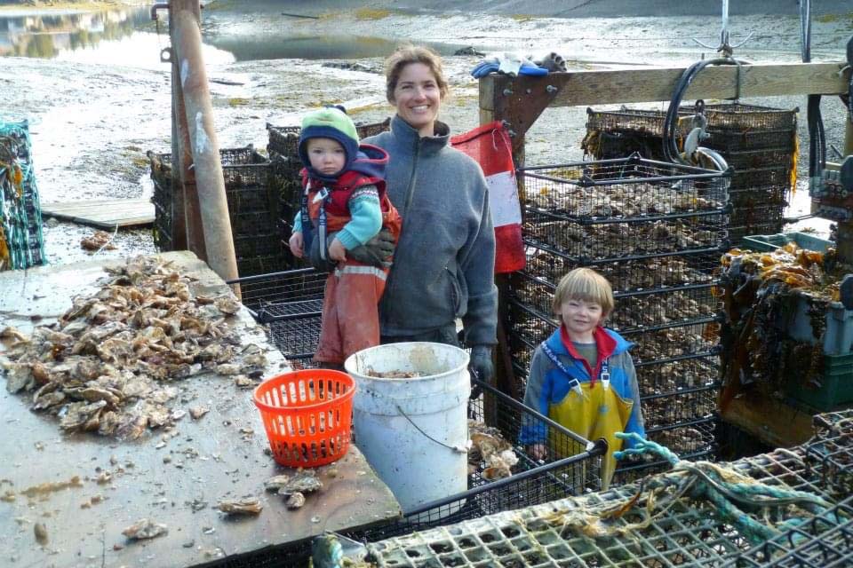 Weatherly Bates and her children surrounded by baskets full of shellfish